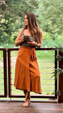 Wildalaya Signature Wrap Skirt back detail, earthy colour, eco-friendly wrap style woman wearing and holding cup in balcony