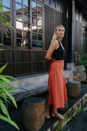 Woman in black top and Wildalaya Wrap Skirt Red Clay